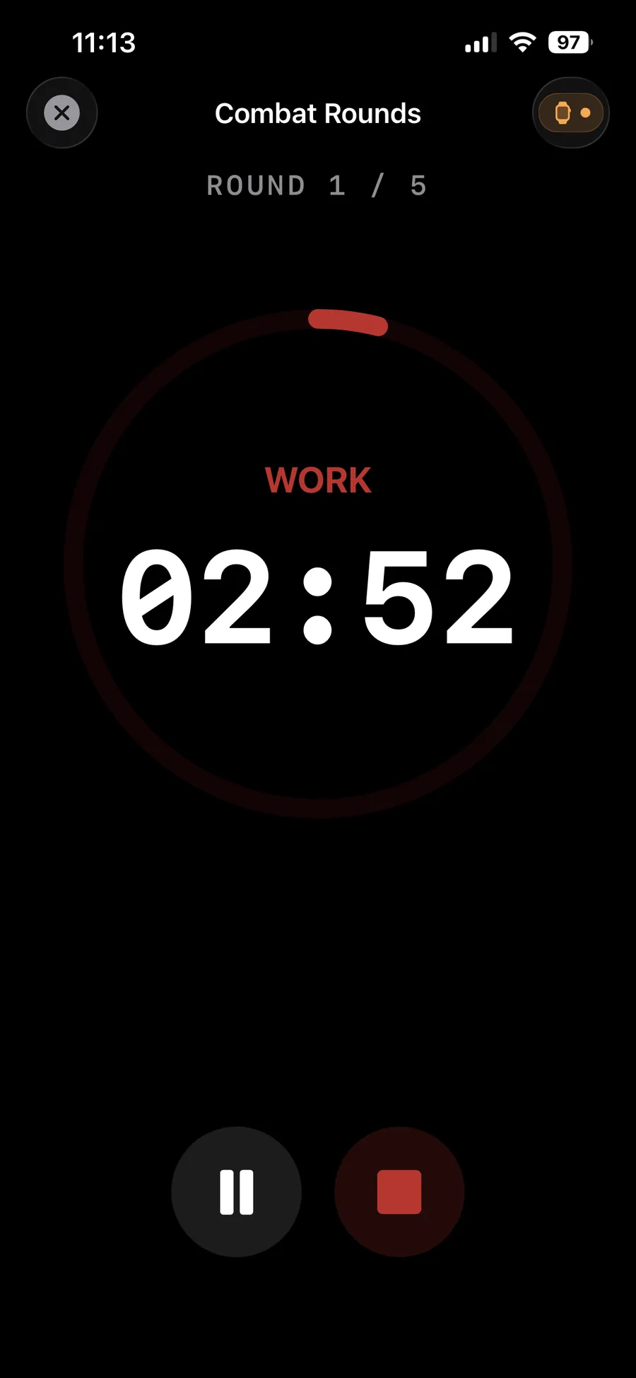 Versus Training Combat Rounds timer mid-session: Round 1 of 5, WORK phase at 02:52 inside a circular progress ring, with Pause and Stop controls below and the Apple Watch handoff indicator in the top right.